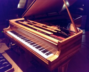The Stuart & Sons studio grand piano. Note the extended range, fourth pedal and striking grain of the sassafras timber.